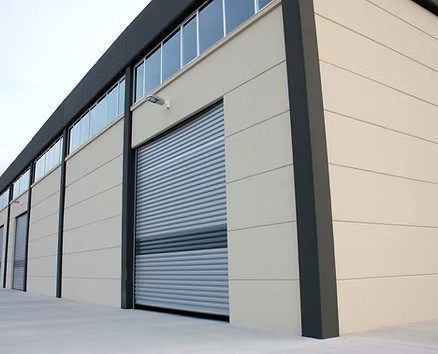 Modern industrial building with a closed grey roller shutter