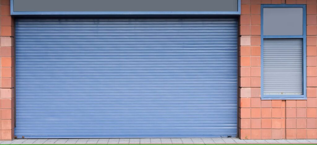 Closed blue roller shutter on a tiled commercial building facade.